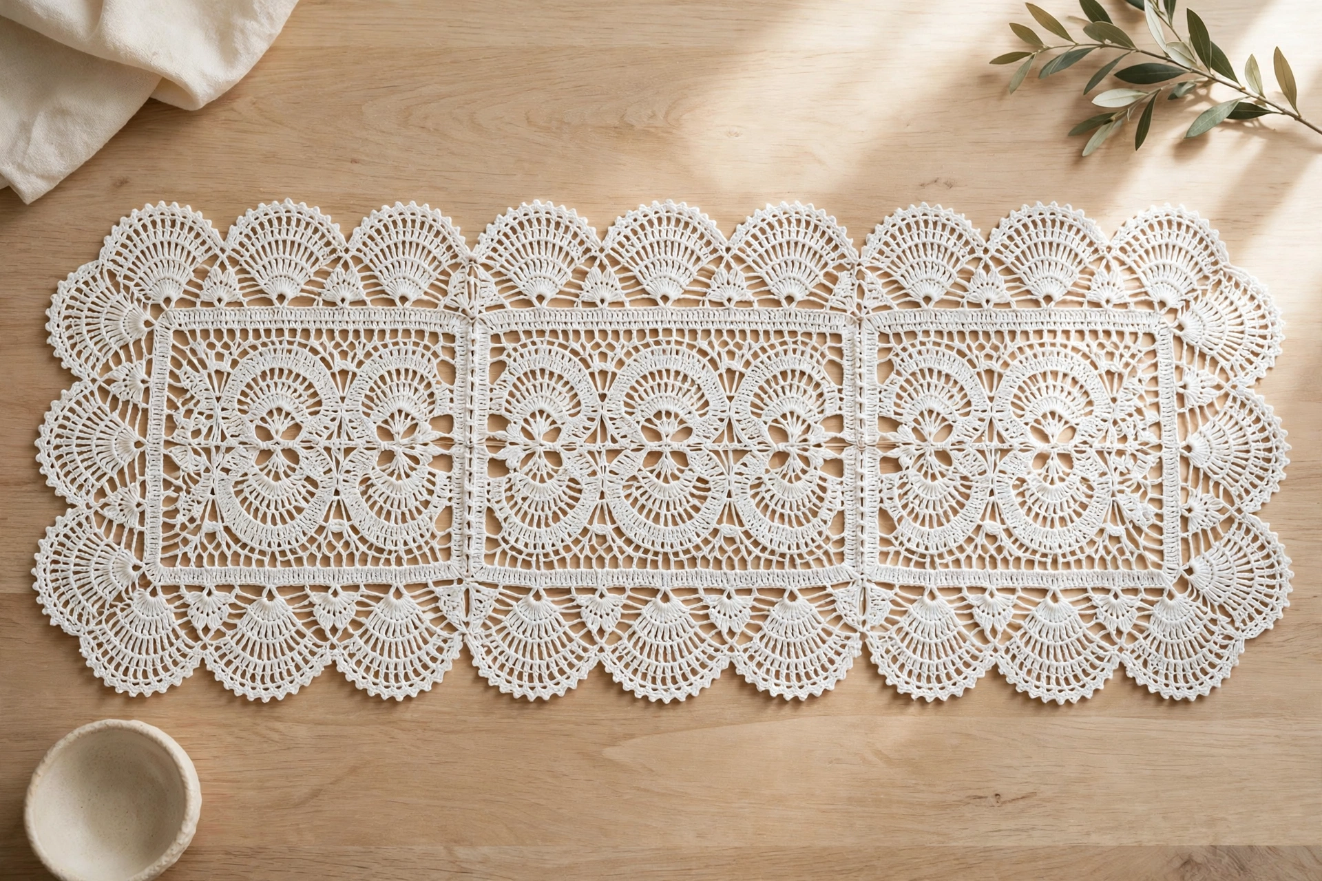 Finished table runner made with the tape lace crochet pattern — three joined fan-scallop lace tapes on a wooden table