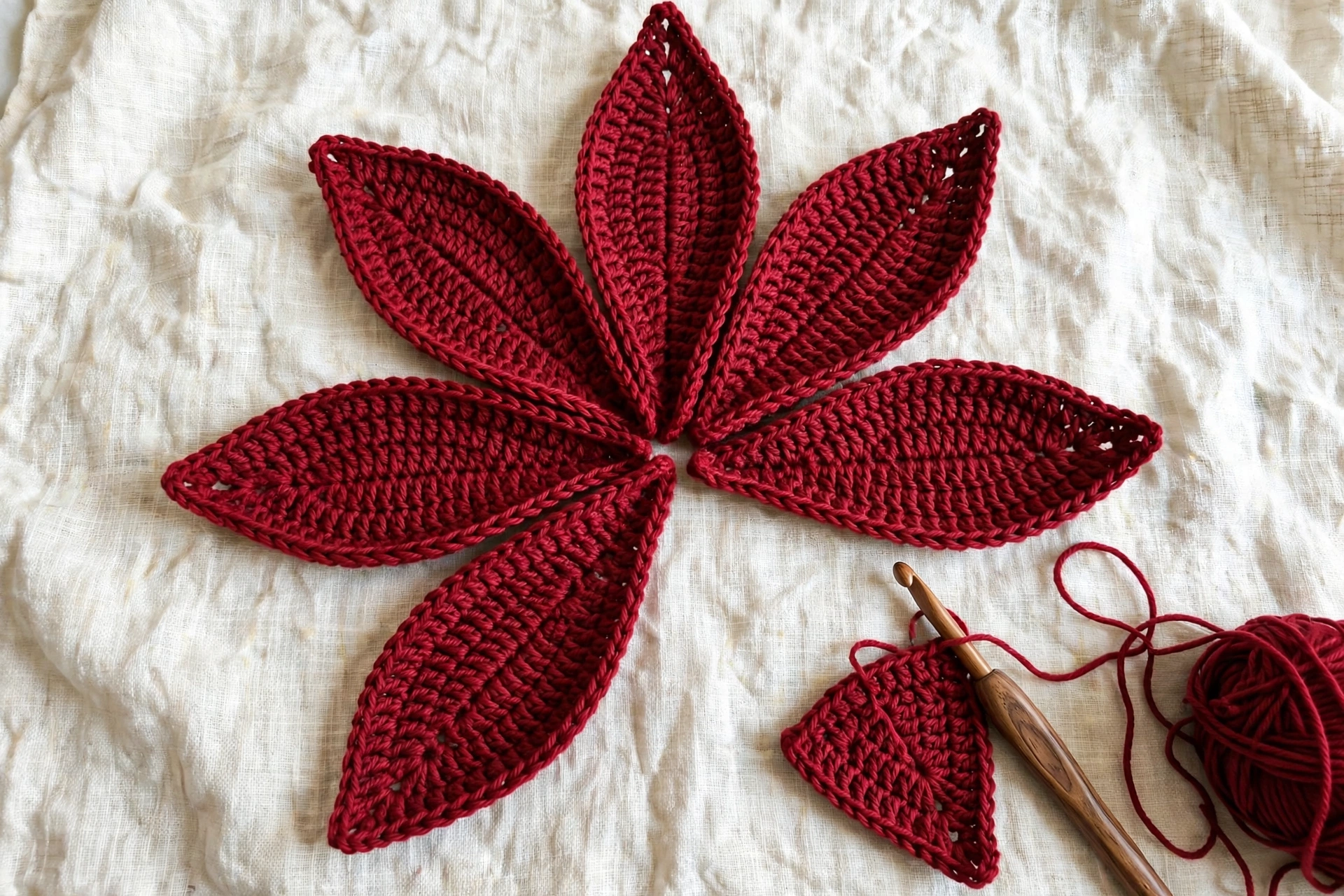 Six large red petals with pointed tips worked for the poinsettia crochet flower pattern