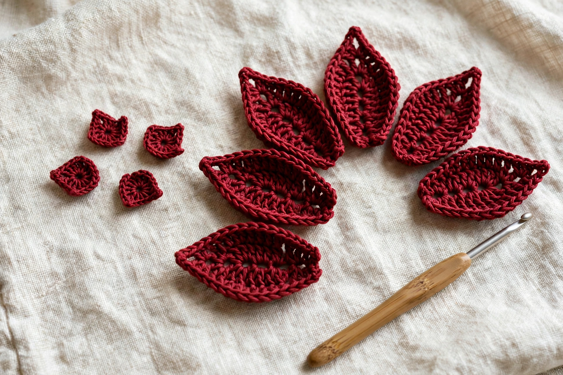 Five small red petals resting beside the large petals of the poinsettia crochet flower pattern