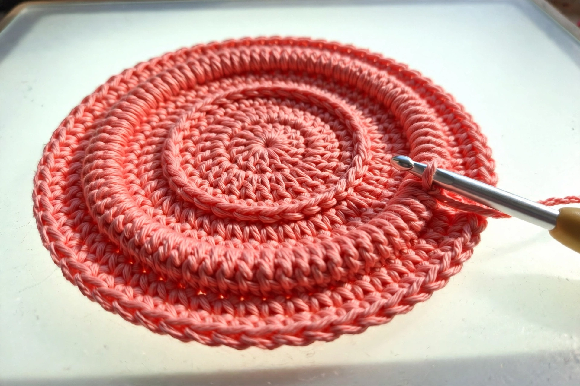 Spiral base of the 3D spiral flower crochet pattern worked out to five rounds with front loop ridges showing