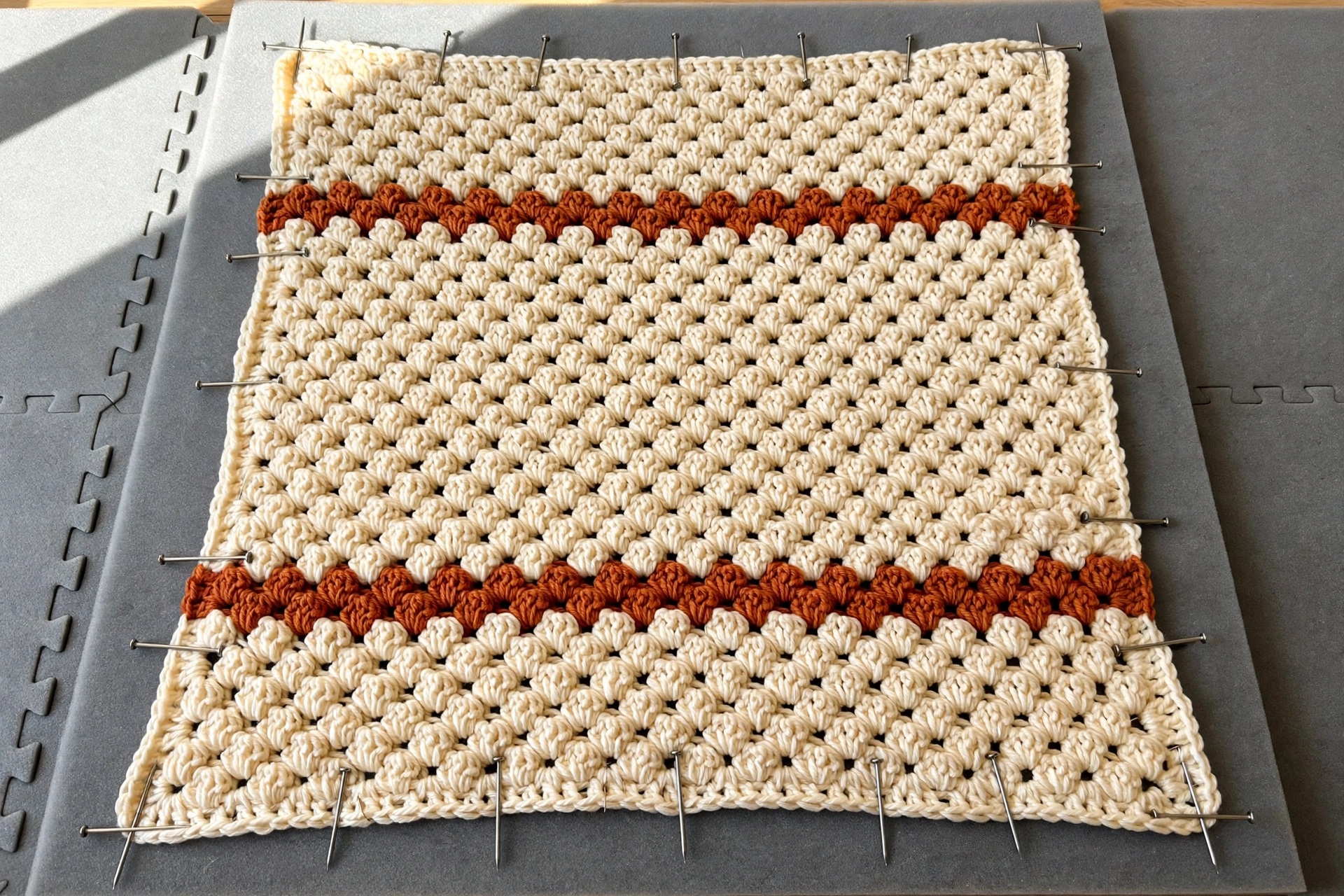 Blocking the finished cosy clusters blanket crochet pattern flat on foam mats